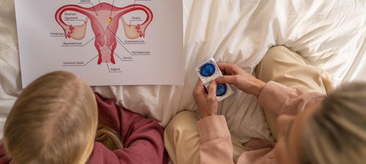 A mother and daughter learning about female reproductive health and contraception.