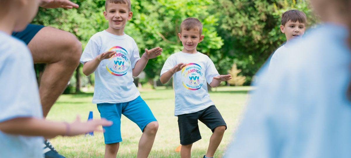 Joyful kids engaging in playful activities in a sunny park, enjoying summer fun together.